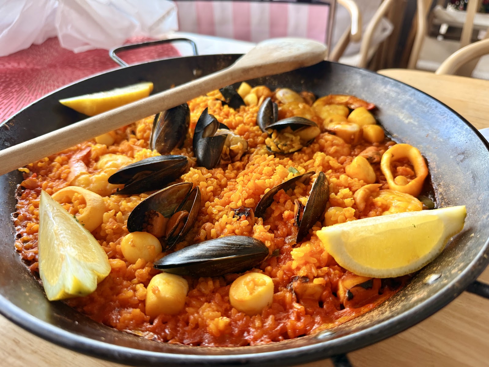 Seafood paella with lemon wedges